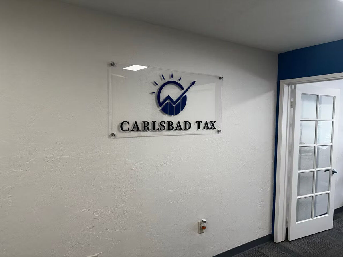 Carlsbad Tax lobby sign beside an office door