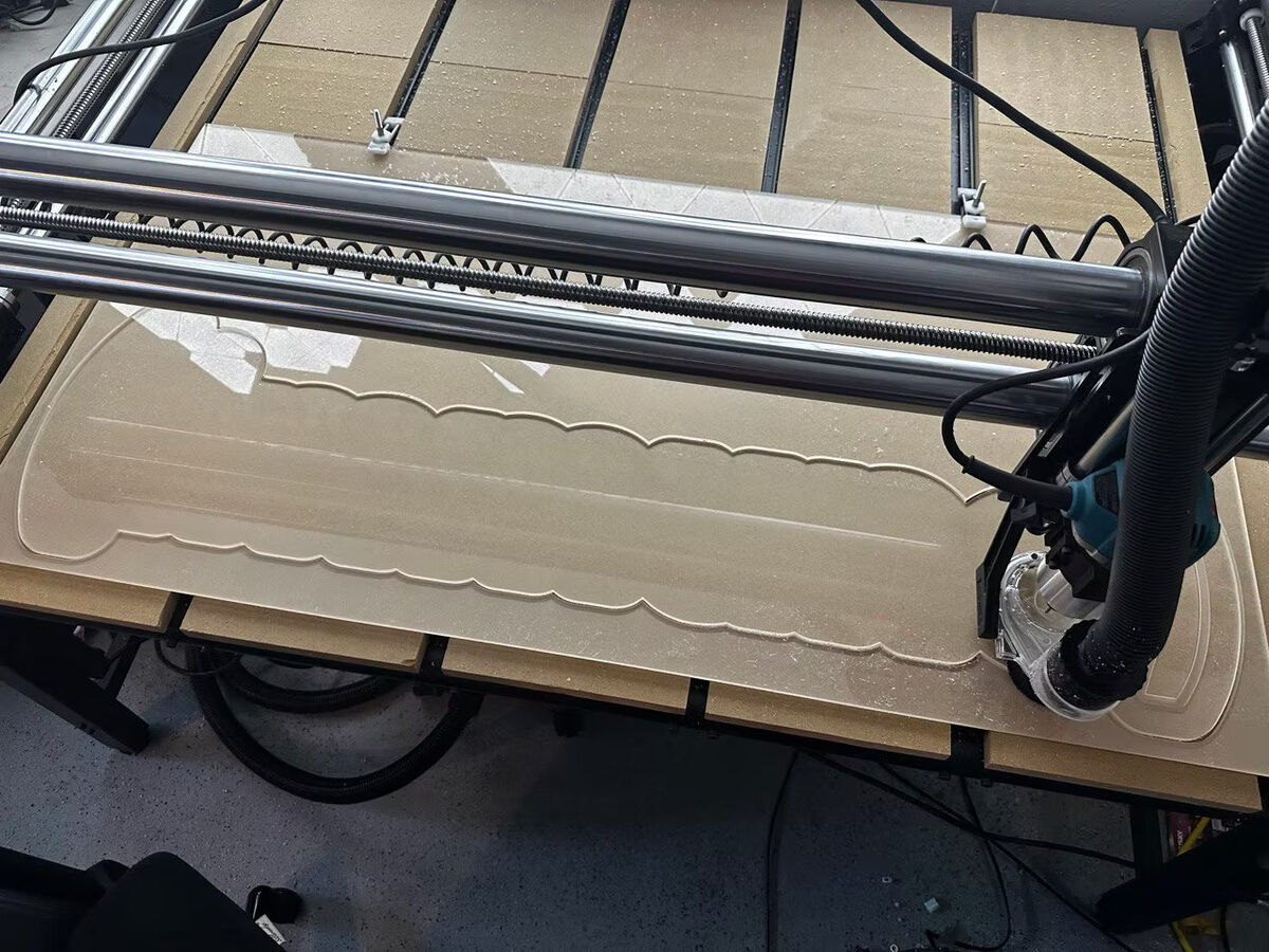 CNC router cutting a clear acrylic panel